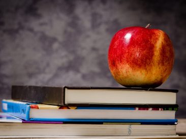close-up-of-apple-on-top-of-books-256520